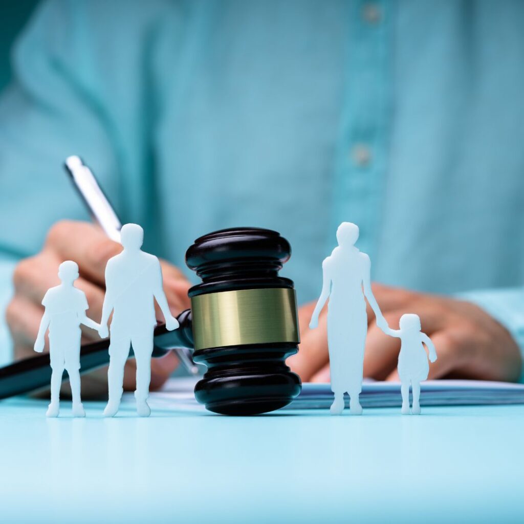 Gavel between family members; person signing paperwork in the background